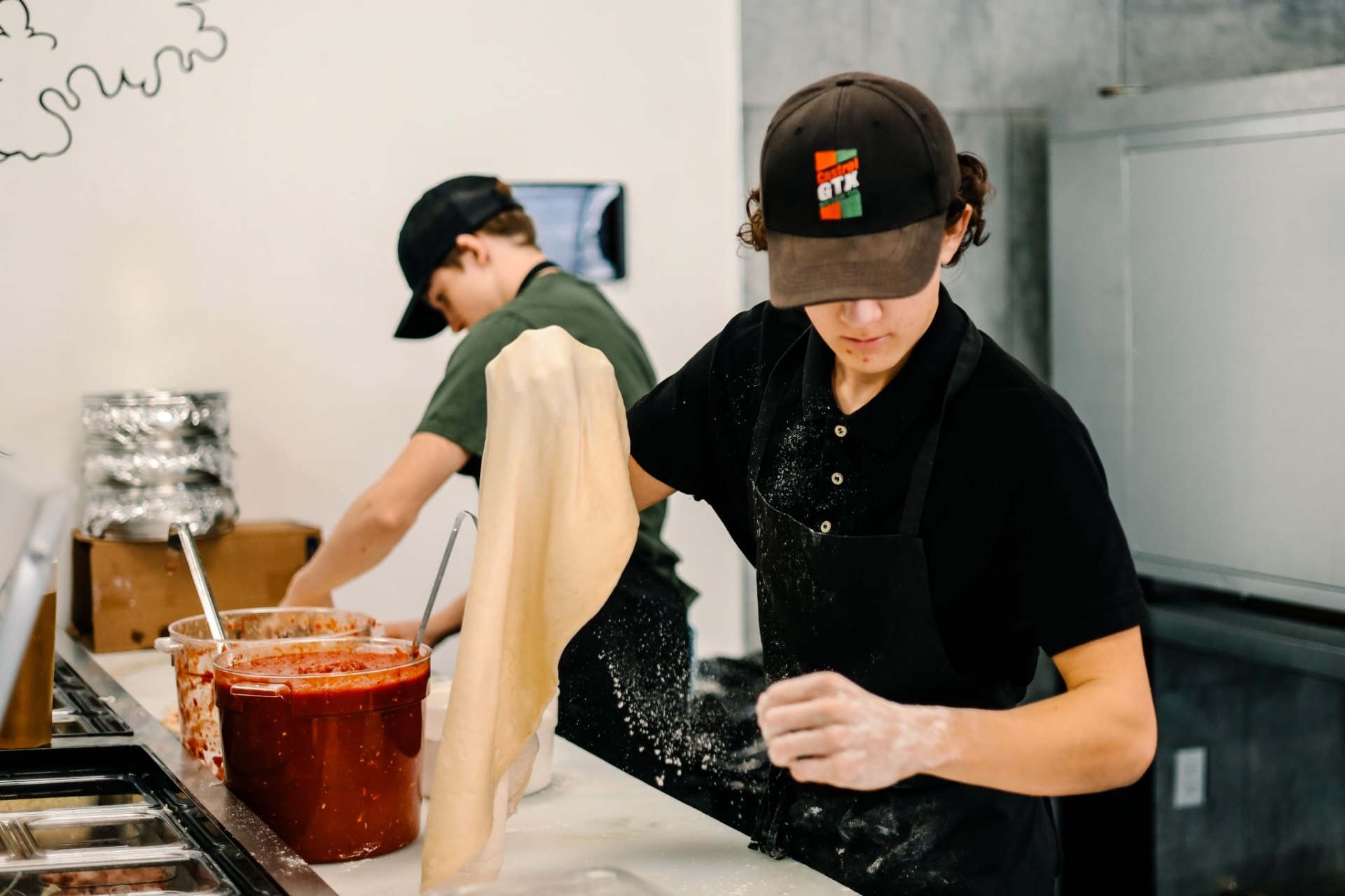 Chef stretching fresh pizza dough